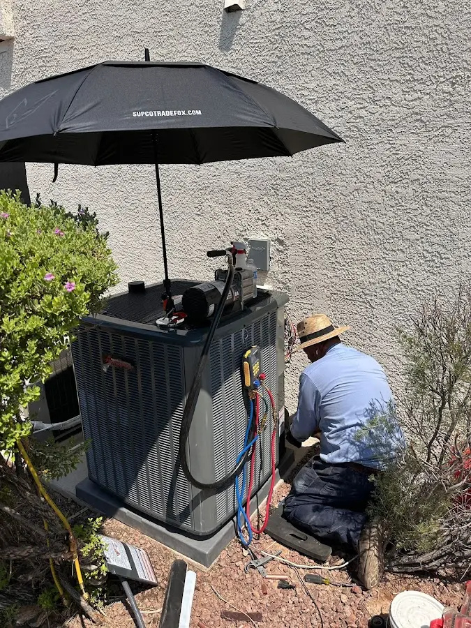 HVAC technician performing outdoor AC maintenance in Woodbridge